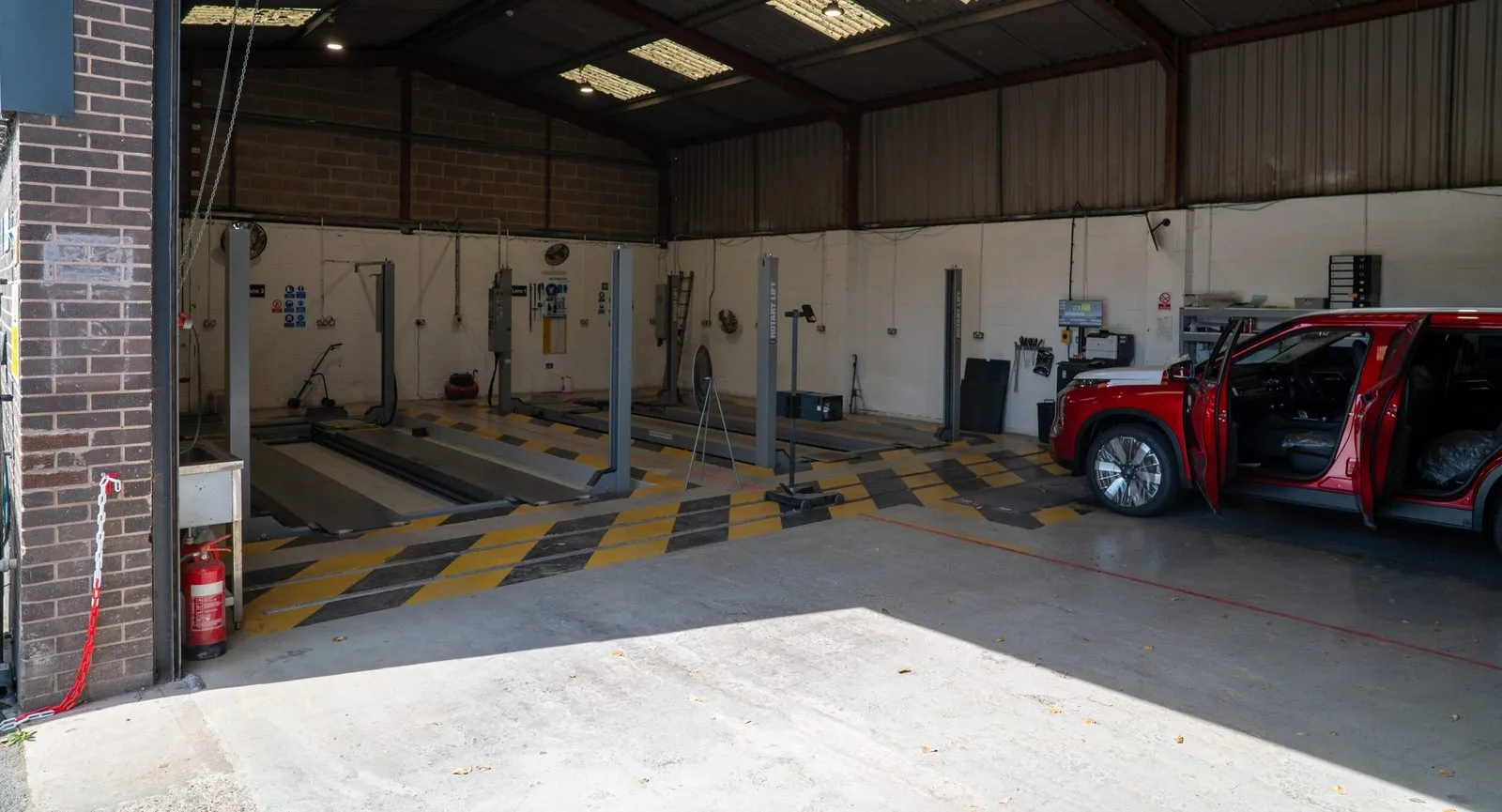 The test lanes at My Car Import, with a red SUV waiting by the door